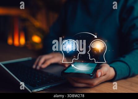 Human and Artificial Intelligence Knowledge Transfer Concept. A person uses phone with two human head profiles, one with an AI brain and human brain, Stock Photo