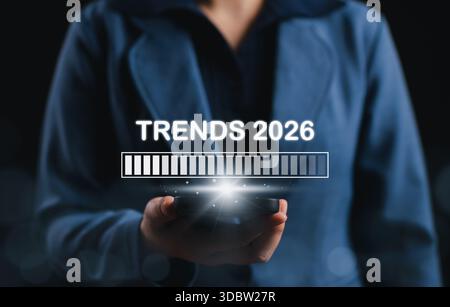 Trends 2026 Future Business and Technology Concept. Businessperson holding phone with loading bar and Trends 2026, future business forecast, Stock Photo