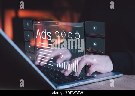 Digital Marketing and Online Advertising Concept. Hand typing on laptop with advertising and data analytics interface projected, Stock Photo
