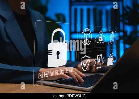 Businesswoman using laptop with virtual lock and cybersecurity icons. Concept of data protection, online privacy, password security, cloud safety, Stock Photo