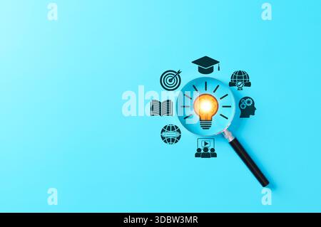 Education and innovation concept, magnifying glass focusing on a lightbulb with icons of learning, goals, skills, and global knowledge, Stock Photo