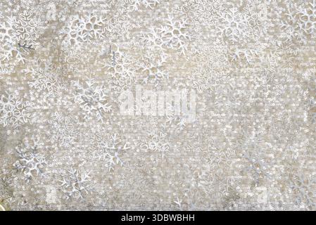Abstract winter background featuring silver snowflake patterns and subtle glitter texture on a neutral beige surface, suitable for holiday design, sea Stock Photo