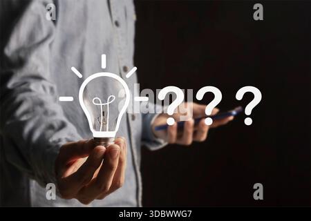 Problem solving concept,creative brainstorming,focus and find a solution. Question mark and light bulb symbolize innovation,thinking and finding answe Stock Photo