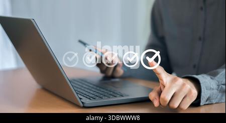 Businessman checks correct approval, acceptance, quality assurance concept, assessment, questionnaire, evaluation, online survey, online exam, checkli Stock Photo