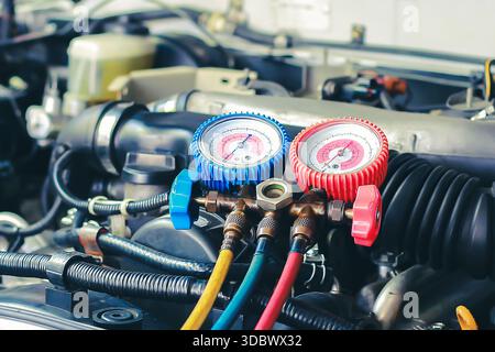 Mechanic Checking Car AC Refrigerant with Manifold Gauge Set Stock Photo