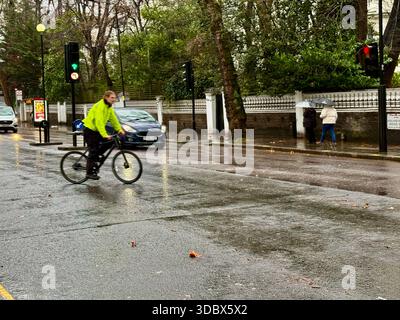 London, UK. 18 December 2025. Pedestrians use umbrellas as traffic moves through rain-soaked streets in central London following heavy downpours. Wet roads and reflections are seen during unsettled weather in the capital. Credit: Alexander Seale/Ģ����ý Live News Stock Photo