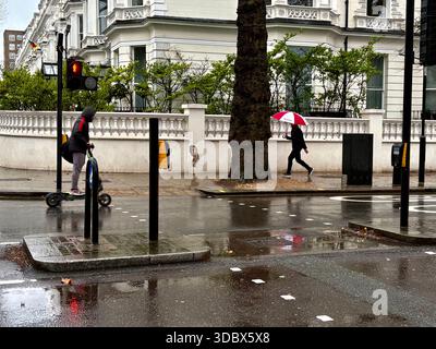 London, UK. 18 December 2025. Pedestrians use umbrellas as traffic moves through rain-soaked streets in central London following heavy downpours. Wet roads and reflections are seen during unsettled weather in the capital. Credit: Alexander Seale/Ģ����ý Live News Stock Photo