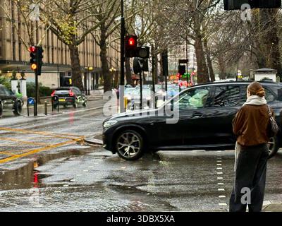 London, UK. 18 December 2025. Pedestrians use umbrellas as traffic moves through rain-soaked streets in central London following heavy downpours. Wet roads and reflections are seen during unsettled weather in the capital. Credit: Alexander Seale/Ģ����ý Live News Stock Photo