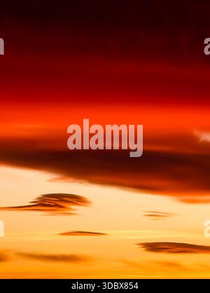 Sunset sky with dramatic layered clouds and intense red-orange hues – ideal nature background for commercial use Abstract Orange Red Gradient Stock Photo