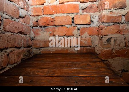 Empty wooden table against old brick wall interior background with copy space Stock Photo