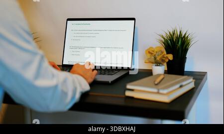 Middle Aged Male Cybersecurity Analyst Conducts Third Party Risk Assessment on Outside Vendor Stock Photo