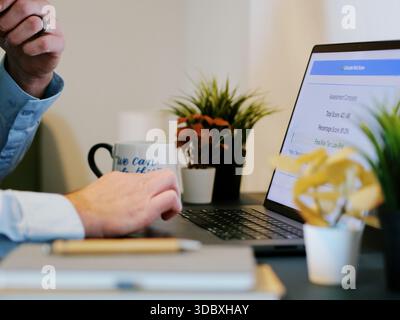 Middle Aged Male Cybersecurity Analyst Conducts Third Party Risk Assessment on Outside Vendor Stock Photo