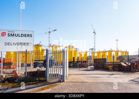 smulders industrial marine construction site large yellow steel structures, tower cranes & fenced entrance near dock facility newcastle tyne river Stock Photo