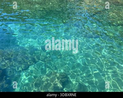 Sea turquoise blue rippled water surface with glittering sun lights Stock Photo