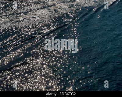 Glittering sea with sun sparkles on blue water surface Stock Photo