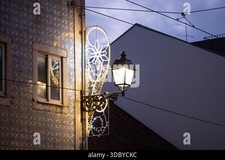 Lisbon Portugal December 05 2025. A young seagull stands on a stone ornament near the Tagus River under cloudy winter evening light. Stock Photo