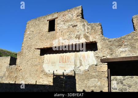 Ancient Roman graffiti on a wall amongst the ruins of Pompeii, Italy Stock Photo