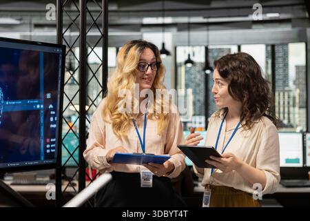 Team of coworkers using strategic artificial intelligence cloud computing to conduct data analysis, optimized decision making and project forecasting. Development with AI automation. Stock Photo