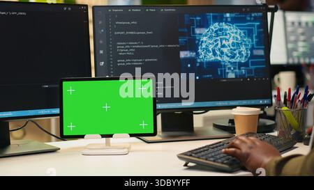 Admin writing code on isolated screen tablet, developing machine learning APIs. IT specialist using chroma key device to troubleshoot software errors using artificial intelligence, camera A Stock Photo