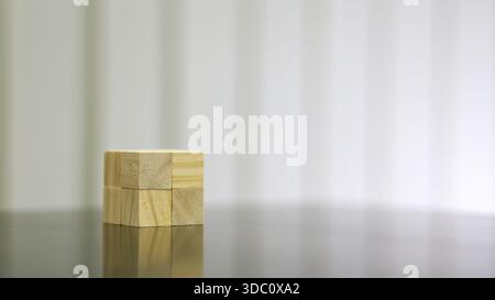 Minimal Wooden Blocks Aligned on Reflective Surface with Copy Space Stock Photo