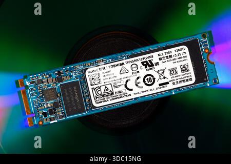 A Toshiba NVMe M.2 SSD memory stick on top of an optical disc. flash memory chips prices have been forecast to rise following news of Micro Technology Stock Photo