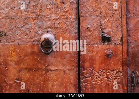 Close Up of Rusty Metal Door with Antique Iron Ring Knocker Stock Photo