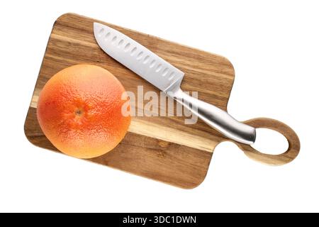One juicy grapefruit with wooden kitchen board and knife on white background, close-up, top view. Stock Photo