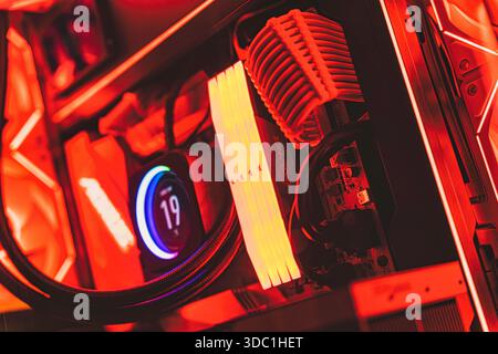 Rovigo, italy 18 december 2025: high-performance computer components with red and orange rgb lighting inside a desktop gaming rig. Displaying advanced Stock Photo