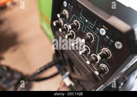 Rovigo, italy 18 december 2025: industrial welding machine control panel with numerous dials and buttons for adjusting parameters and settings in a wo Stock Photo