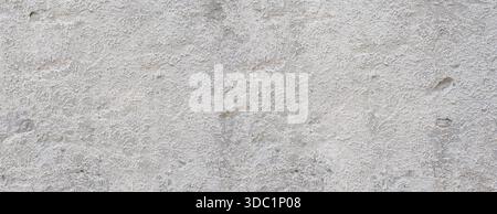 Rough gray concrete plaster creating an aged textured wall surface Stock Photo