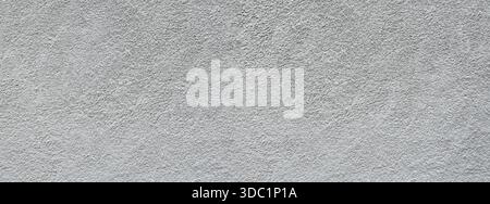 Grey textured concrete wall surface providing a rough abstract background Stock Photo