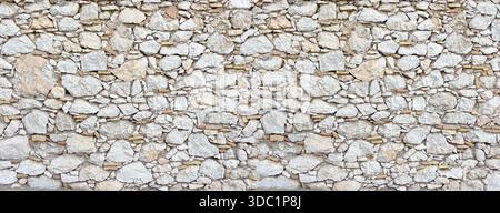 Ancient stone wall constructing rustic natural background texture Stock Photo