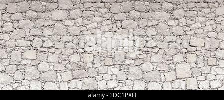 Gray stone wall showing rough masonry construction and irregular stone shapes Stock Photo