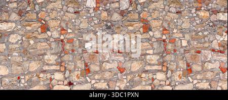 Ancient stone and brick wall presenting a rustic surface texture Stock Photo