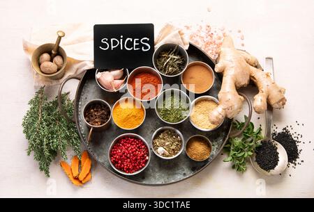 Many different spices. A collection of various spices and herbs on a light background. Top view. Stock Photo