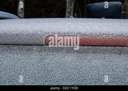 Ice frozen on the roof and window of a car Stock Photo