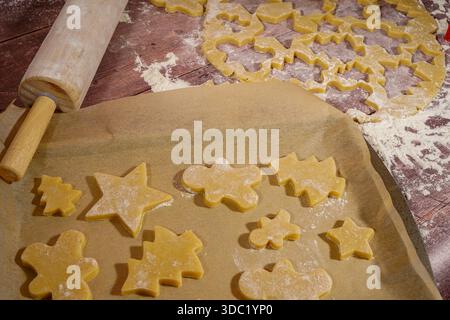 Cut out Christmas cookies on baking sheet with parchment paper Stock Photo