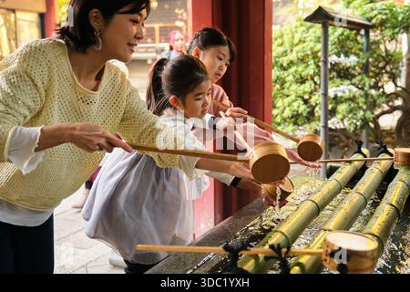 Purification Ritual Japan Japanese family performing purification ritual at Chozuya Stock Photo ...