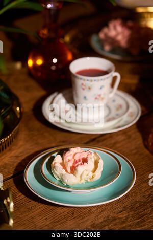 Delicate dessert and tea set on a wooden table in a cozy setting Stock Photo