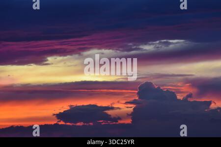 Close-up of the sky only, highlighting the marvelous blend of fiery sunset light and soft, wispy cloud textures. Perfect natural backdrop. Stock Photo
