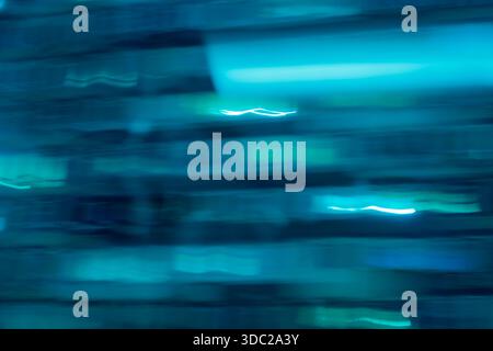 Abstract teal blue motion blur background. Dark horizontal light streaks texture with cyberpunk vibe. Stock Photo