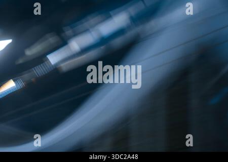 Abstract dark blue curved motion blur background. Smooth sweeping light lines texture representing speed. Stock Photo