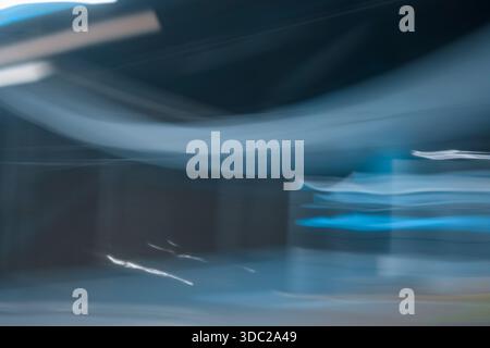 Abstract dark blue motion blur background. Smooth curved light streaks representing speed, night city traffic and technology flow. Stock Photo