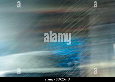 Abstract grey and blue speed motion blur texture. Fast moving lines background resembling rain or wind. Stock Photo