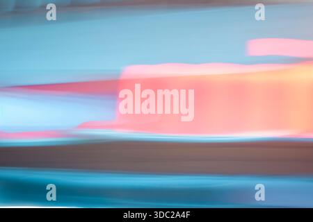 Abstract horizontal motion blur texture. Soft pastel blue and pink light streaks background with retro synthwave aesthetic. Stock Photo