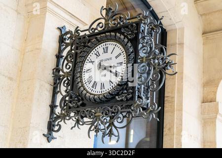 Paris, France - October 29, 2025: Old clock Henry Lepaute 1885 on wall LA POSTE Paris Louvre post office. Stock Photo