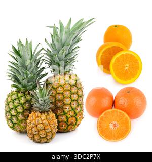 A vibrant collection of ripe pineapples, oranges, and tangerines isolated on a clean white background. Stock Photo