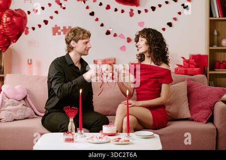 Young Man and Young Woman Toasting Drinks Celebrating Valentines Day Stock Photo