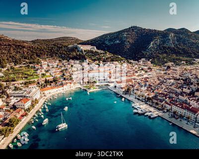 Aerial view of the turquoise sea embracing the historic town and harbor with boats, nestled against the mountainous backdrop, Split, Split-Dalmatia Co Stock Photo