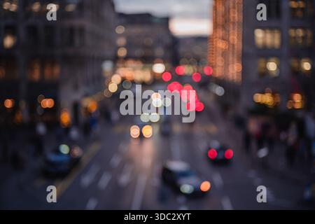 Blurred city street at night with traffic lights creating a bokeh effect and moody atmosphere Stock Photo